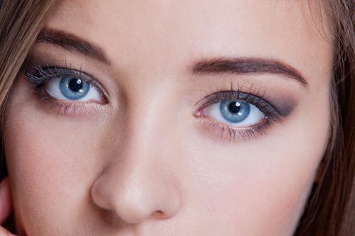 Cropped portrait of a woman with a lovely complexion and beautiful big blue eyes wearing subtle eye makeup